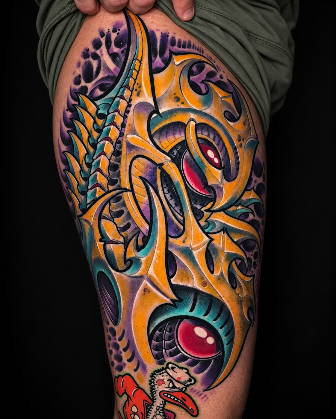 Bright color biomechanical thigh tattoo by Miami tattoo artist Adrian Aguirre