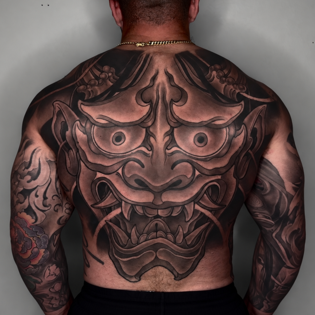 Large black and gray Hannya mask back piece tattoo by Miami tattoo artist Adrian Aguirre