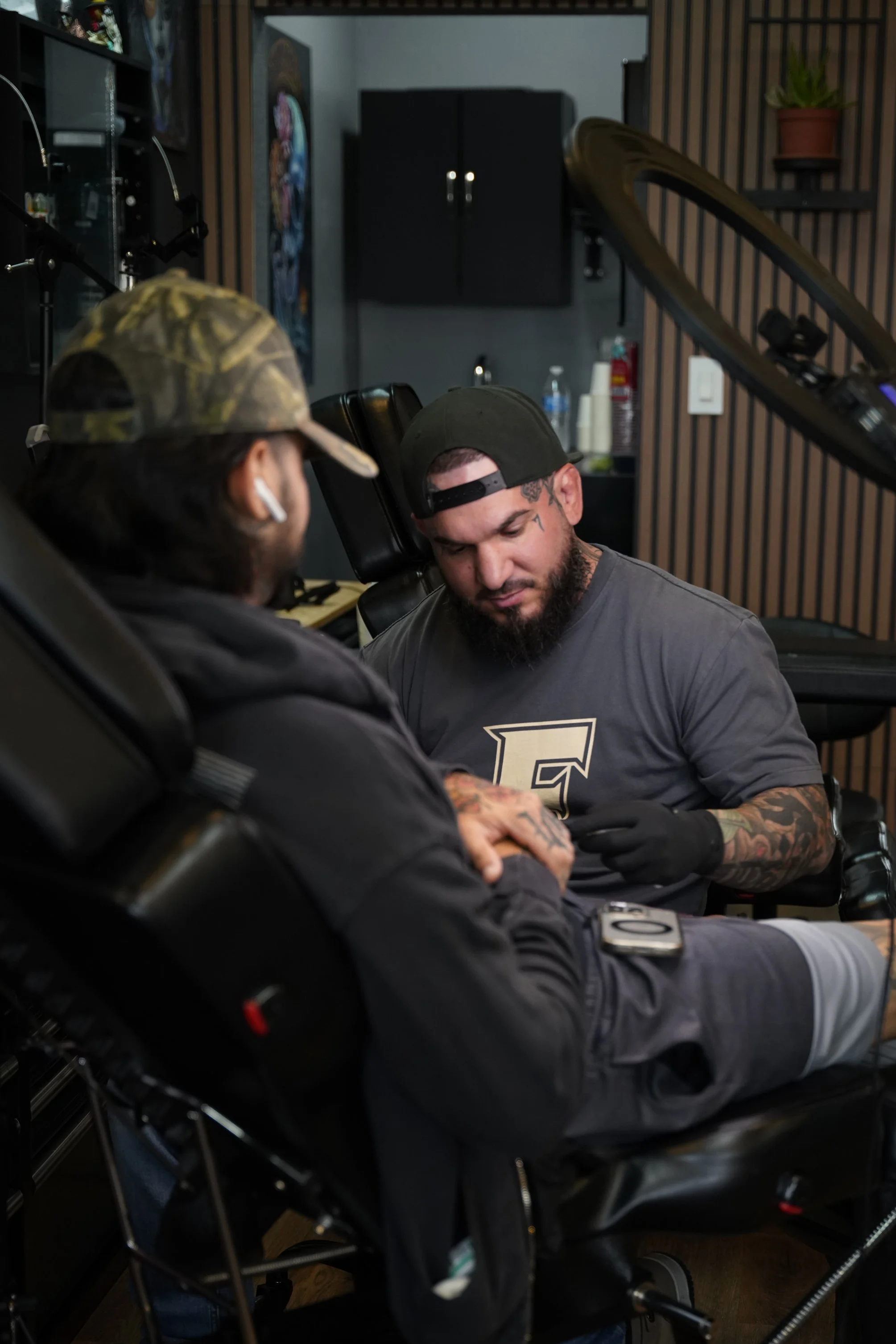 Miami tattoo artist Adrian Aguirre working with a client at Black Nova Tattoo Collective