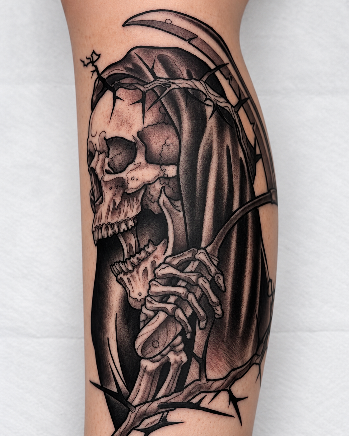 Black and gray Grim Reaper tattoo with scythe and skeletal hands by Miami tattoo artist Adrian Aguirre