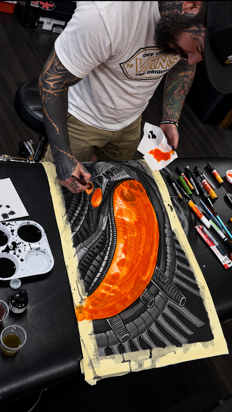 Adrian Aguirre creating a custom mixed-media painting in Miami using acrylic paint, markers, and spray paint