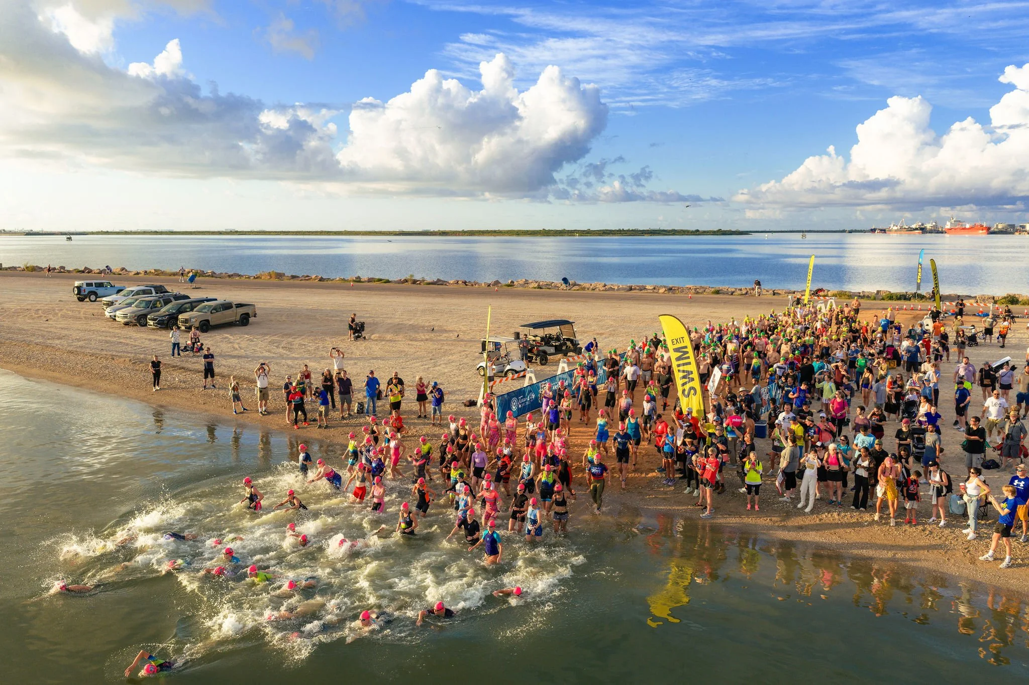 Athletes entering the water at the swim start