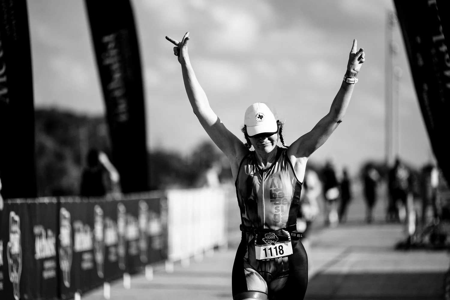 Athlete celebrating while crossing the Texas City finish line