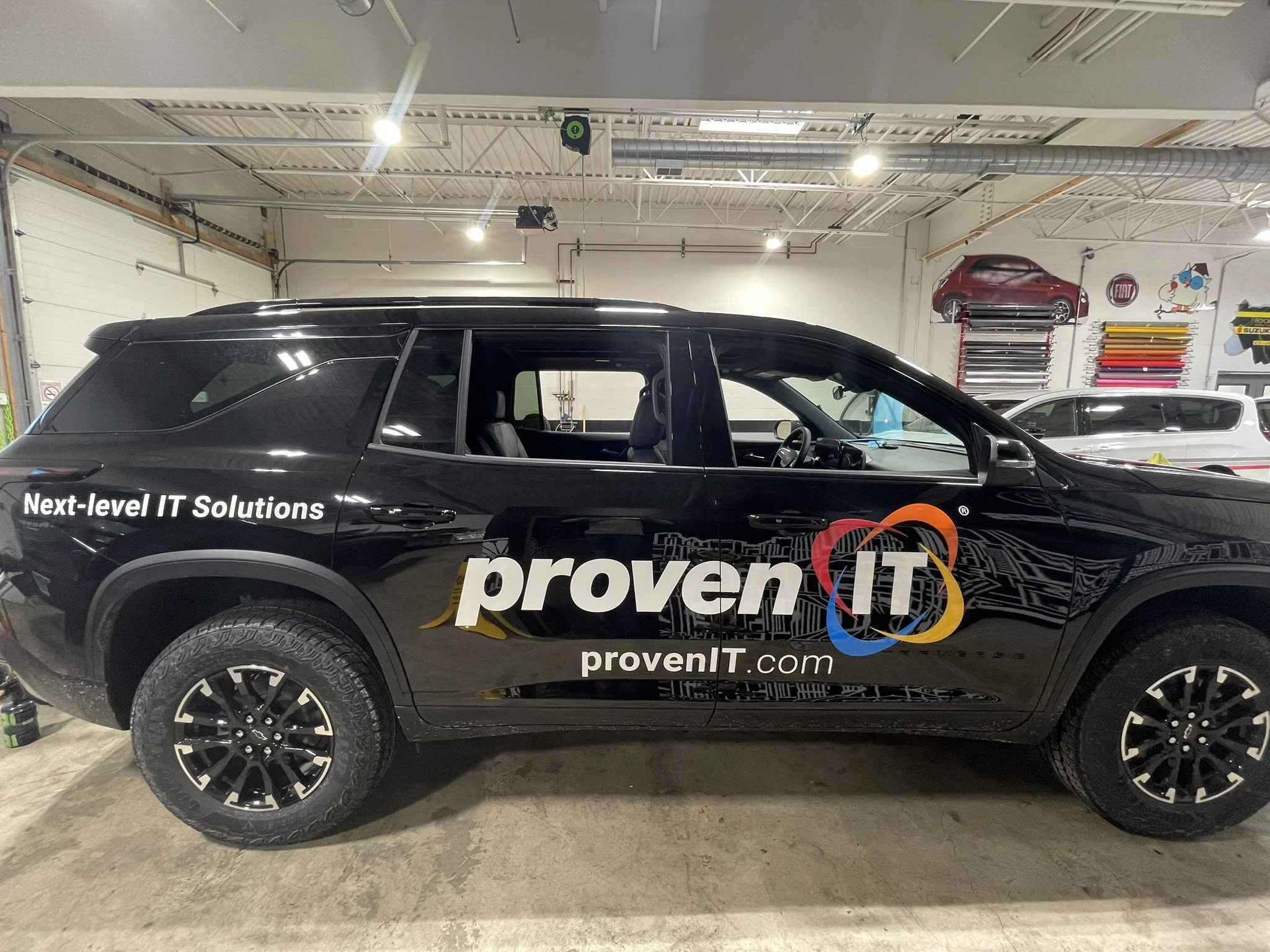 Black SUV with Proven IT logo fleet graphics