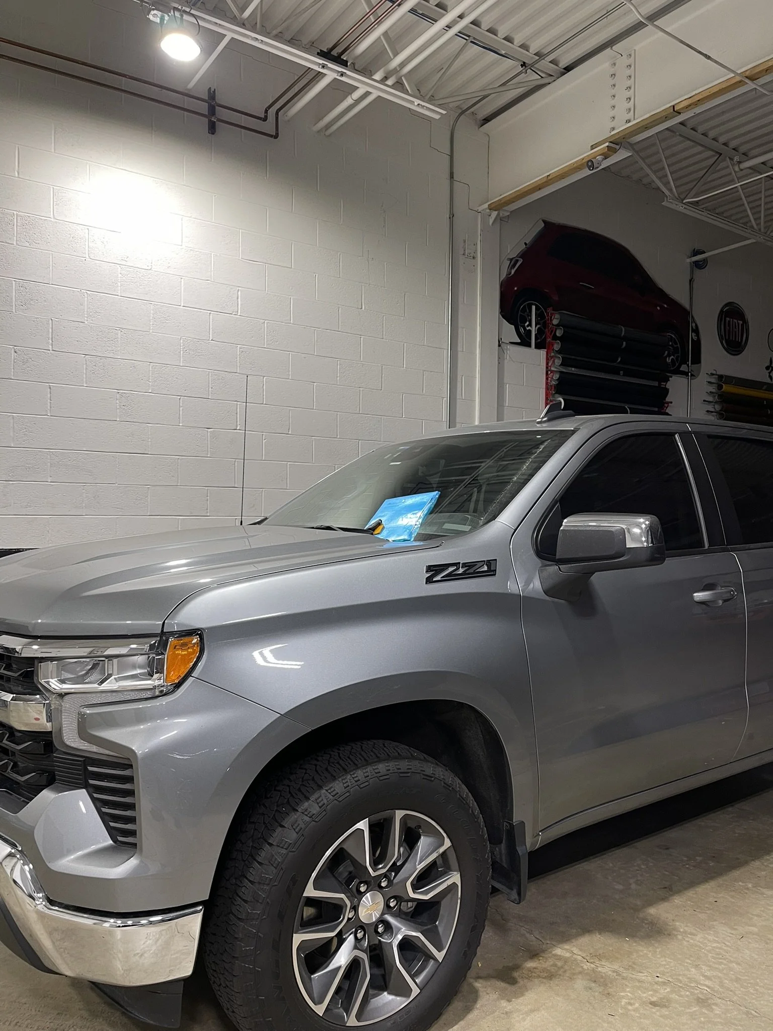 Silver Chevy Silverado inside the Element Graphics shop in Mokena, IL, for paint protection film and ceramic coating