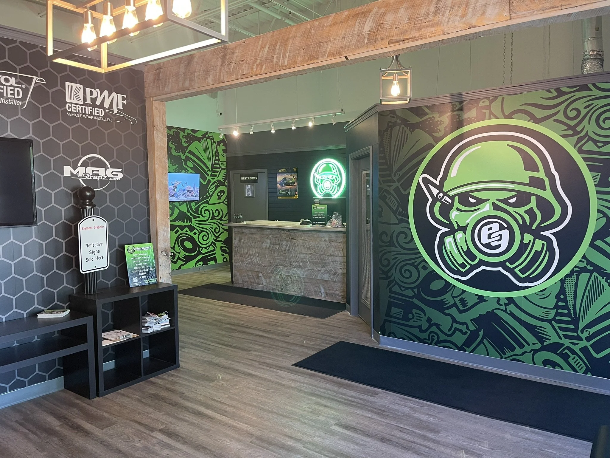 Custom green and black wall mural in the Element Graphics shop lobby in Mokena, IL