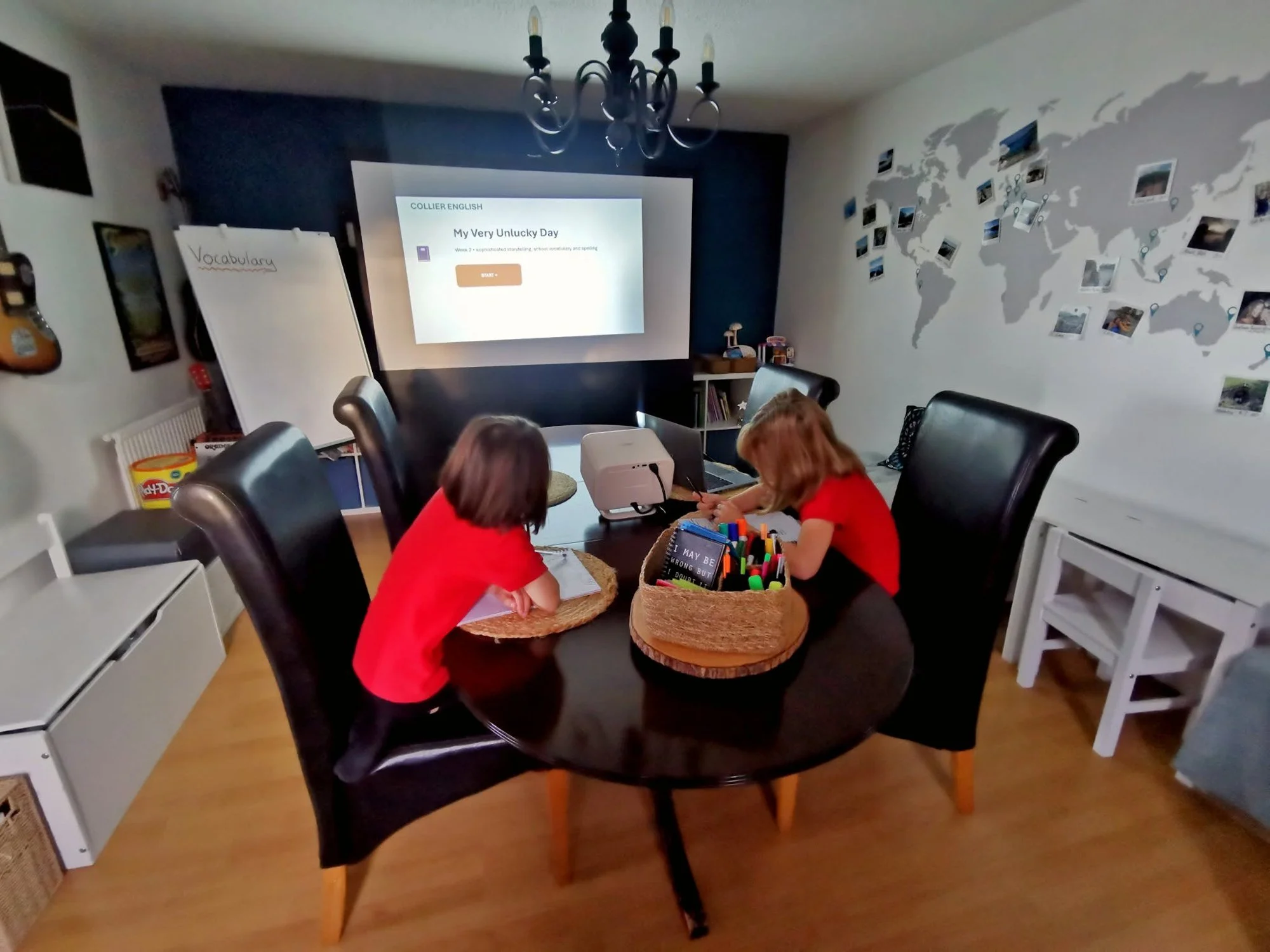 Two children working at a round table in the teaching room
