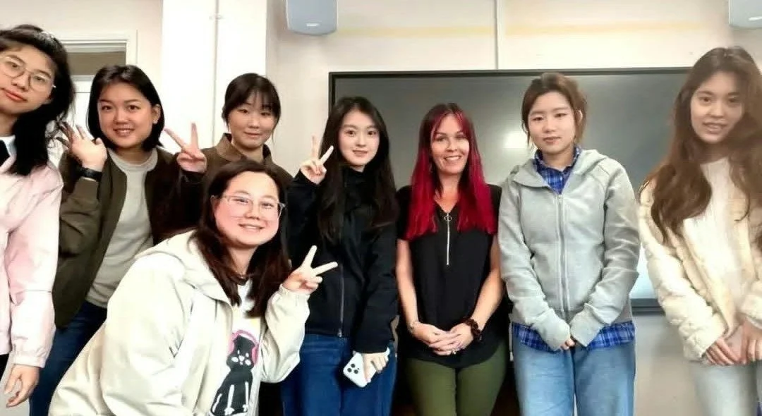 Sarah with a group of English learners in a classroom