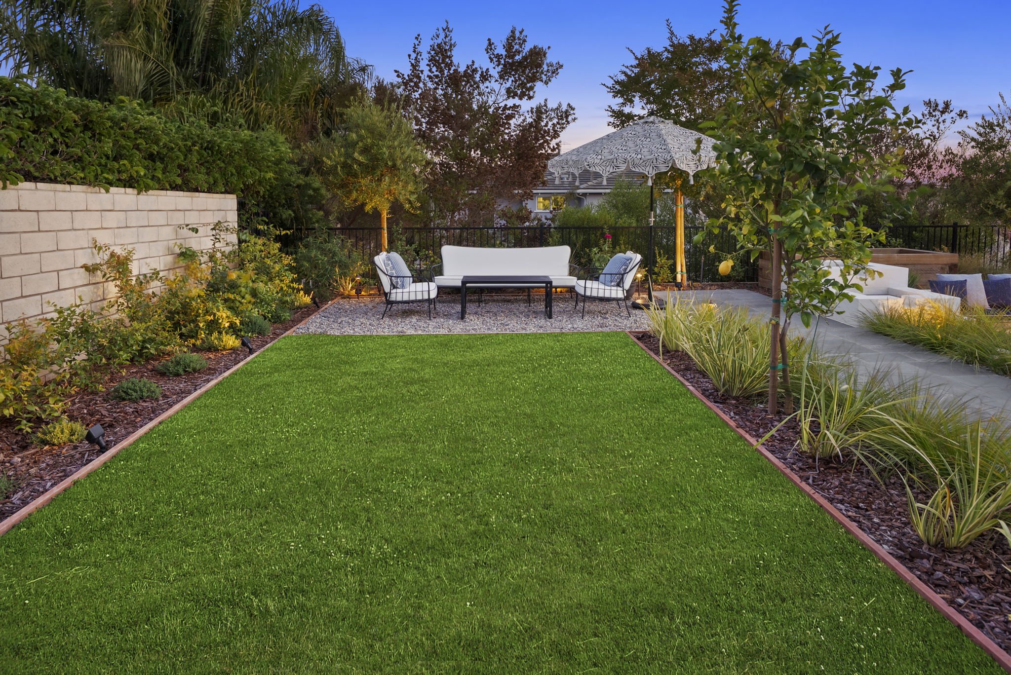 Backyard garden landscape design with planting beds and lawn