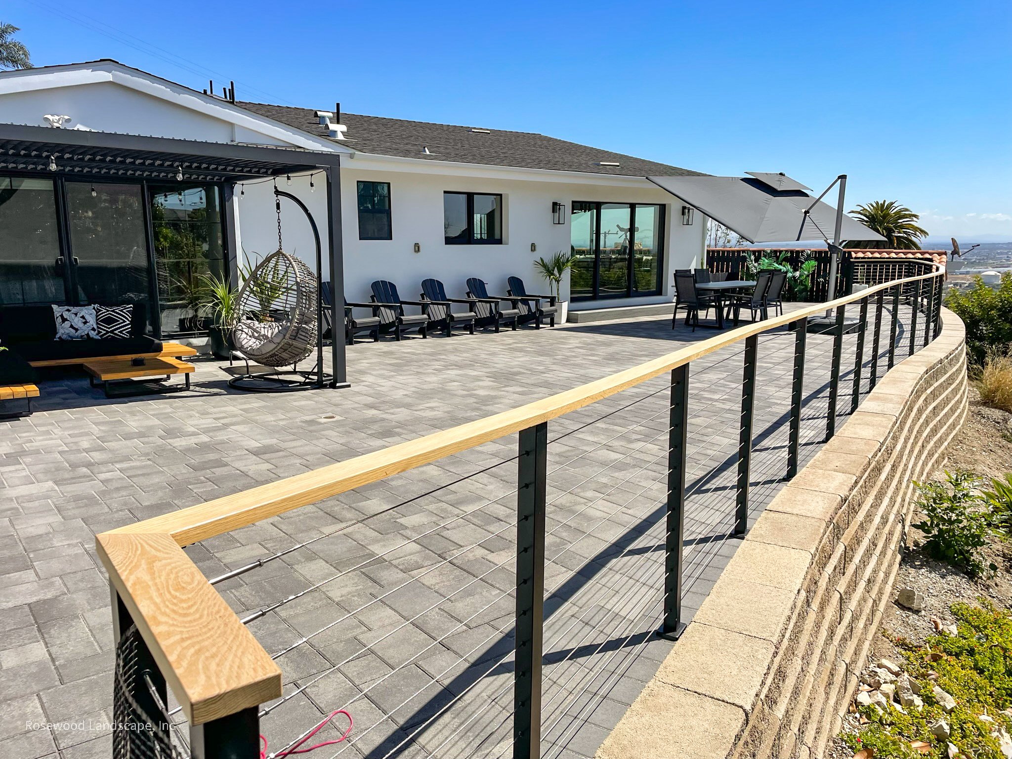 Modern paver patio and outdoor living space by Rosewood Landscape
