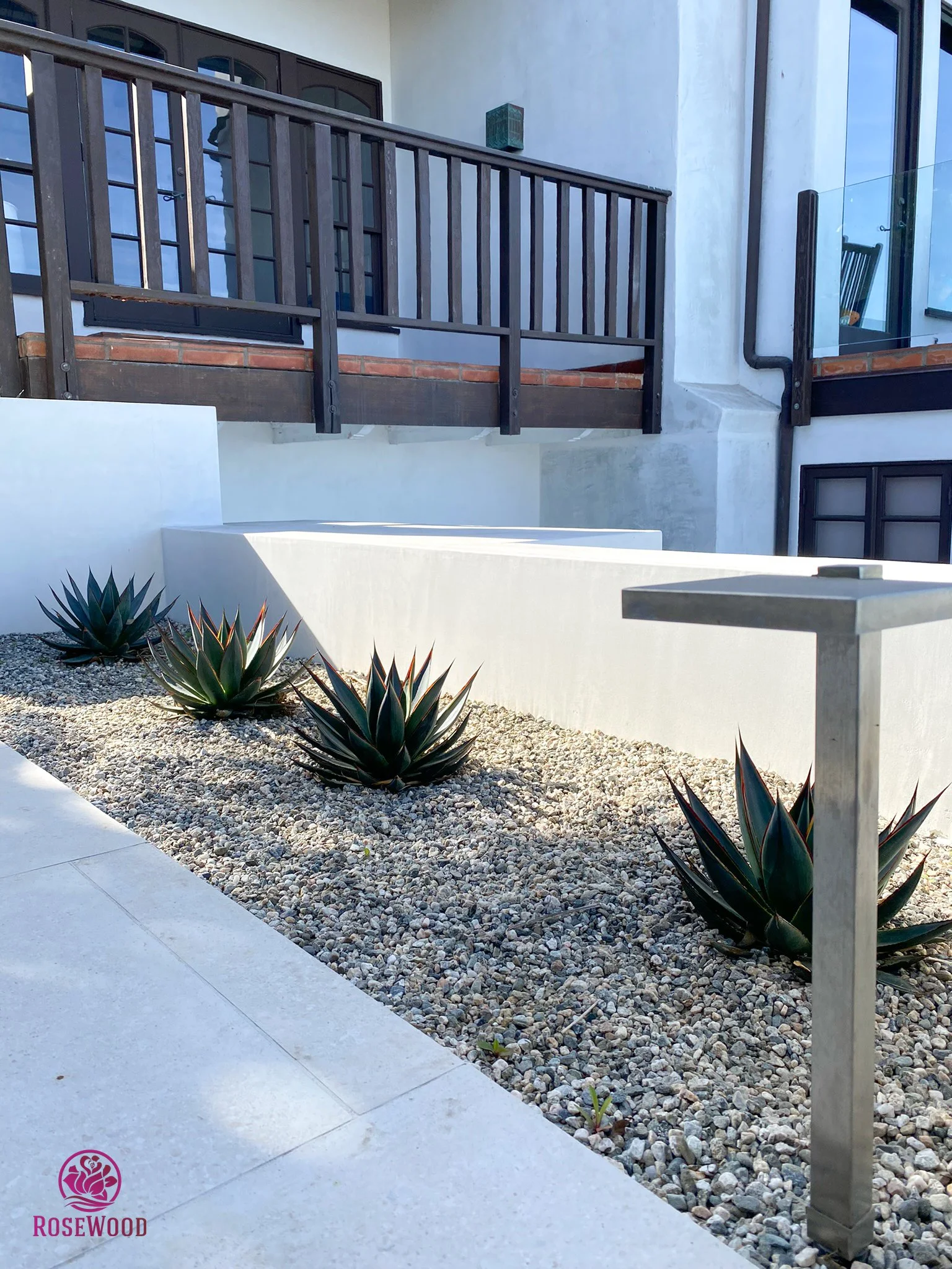 Agave rock garden with modern landscape lighting by Rosewood Landscape