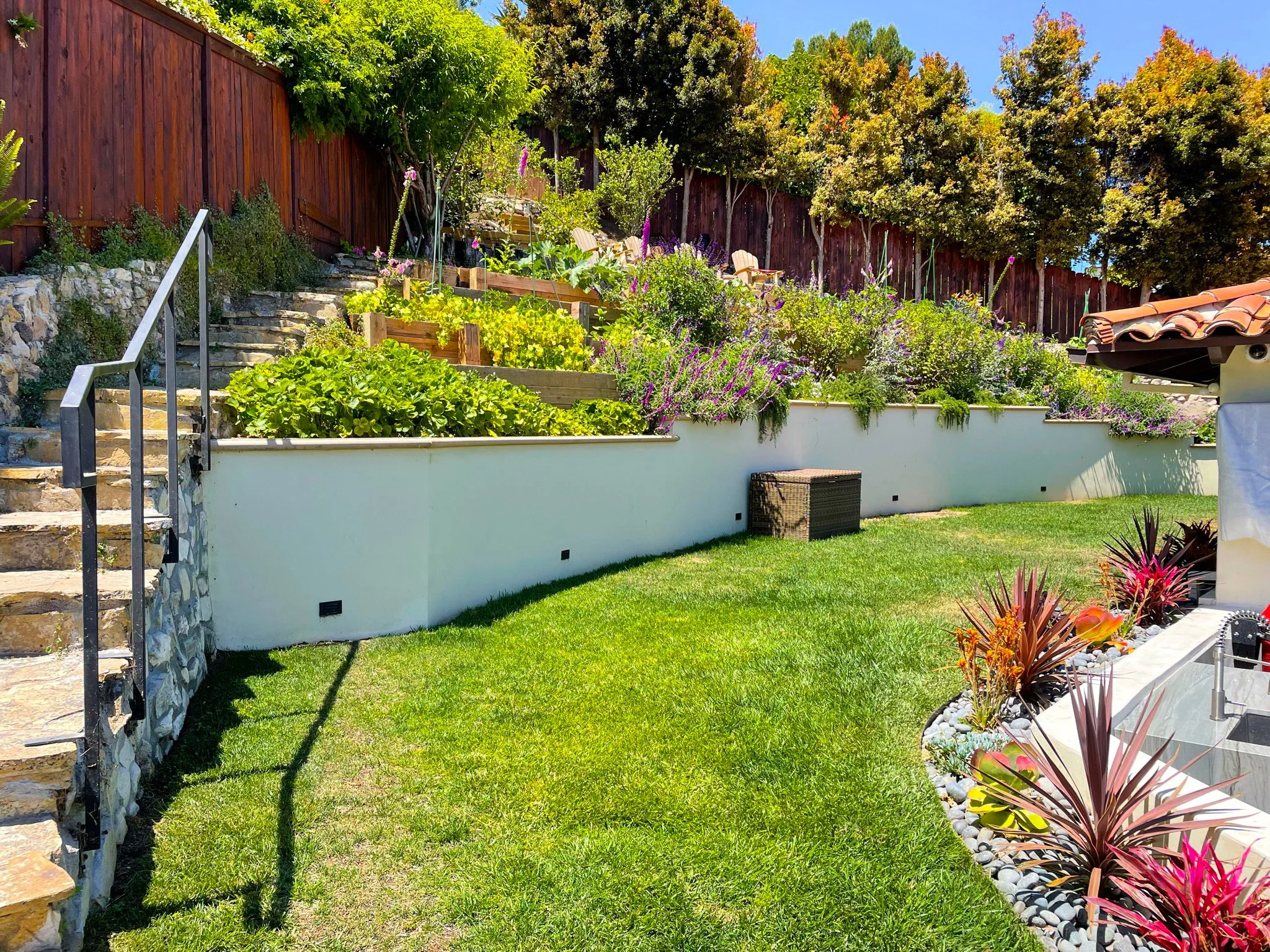 Tiered hillside garden incorporated into a residential backyard landscape