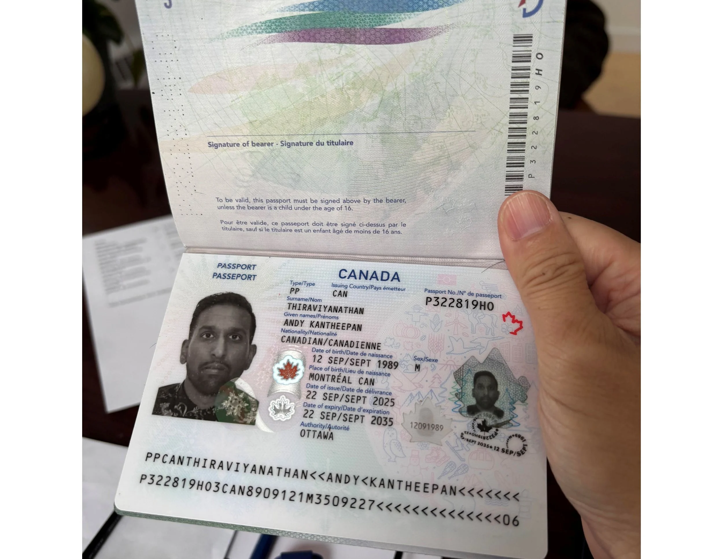 A person holding a Canadian passport, opened to show the identity page. The passport contains a black and white photo of a man, with personal details including name, nationality, date of birth, and passport expiration date. The page also displays holographic security elements and text in both English and French.