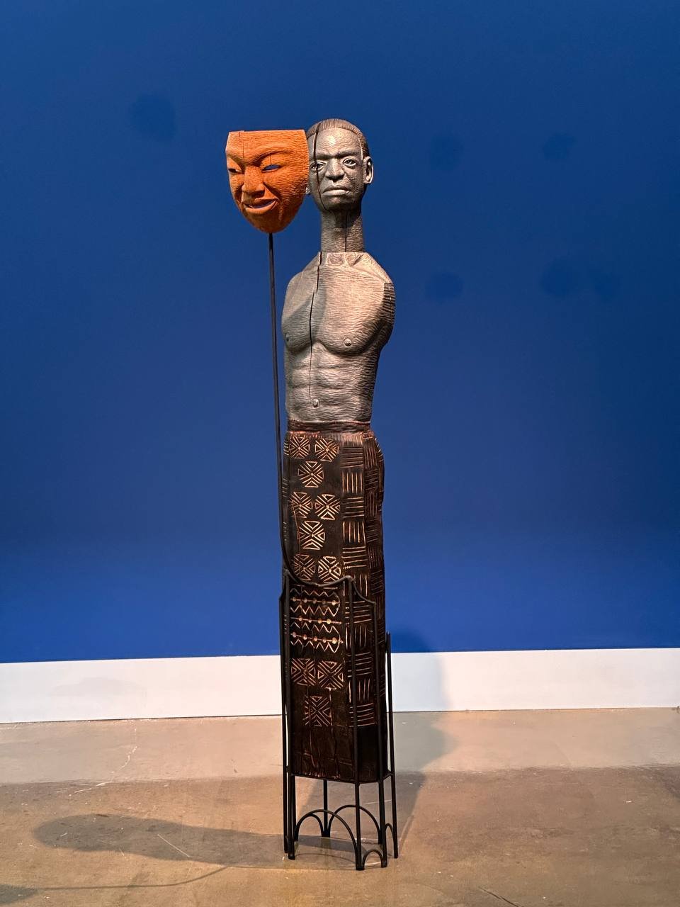 Cover up
2024
Sculpture
Wood & metal
69.5" X 18.7" X 17"

This male figurative sculpture is carved from wood and explores the contrast between outward appearance and inner emotion. The figure has a somber countenance and is bare-chested, with no arms