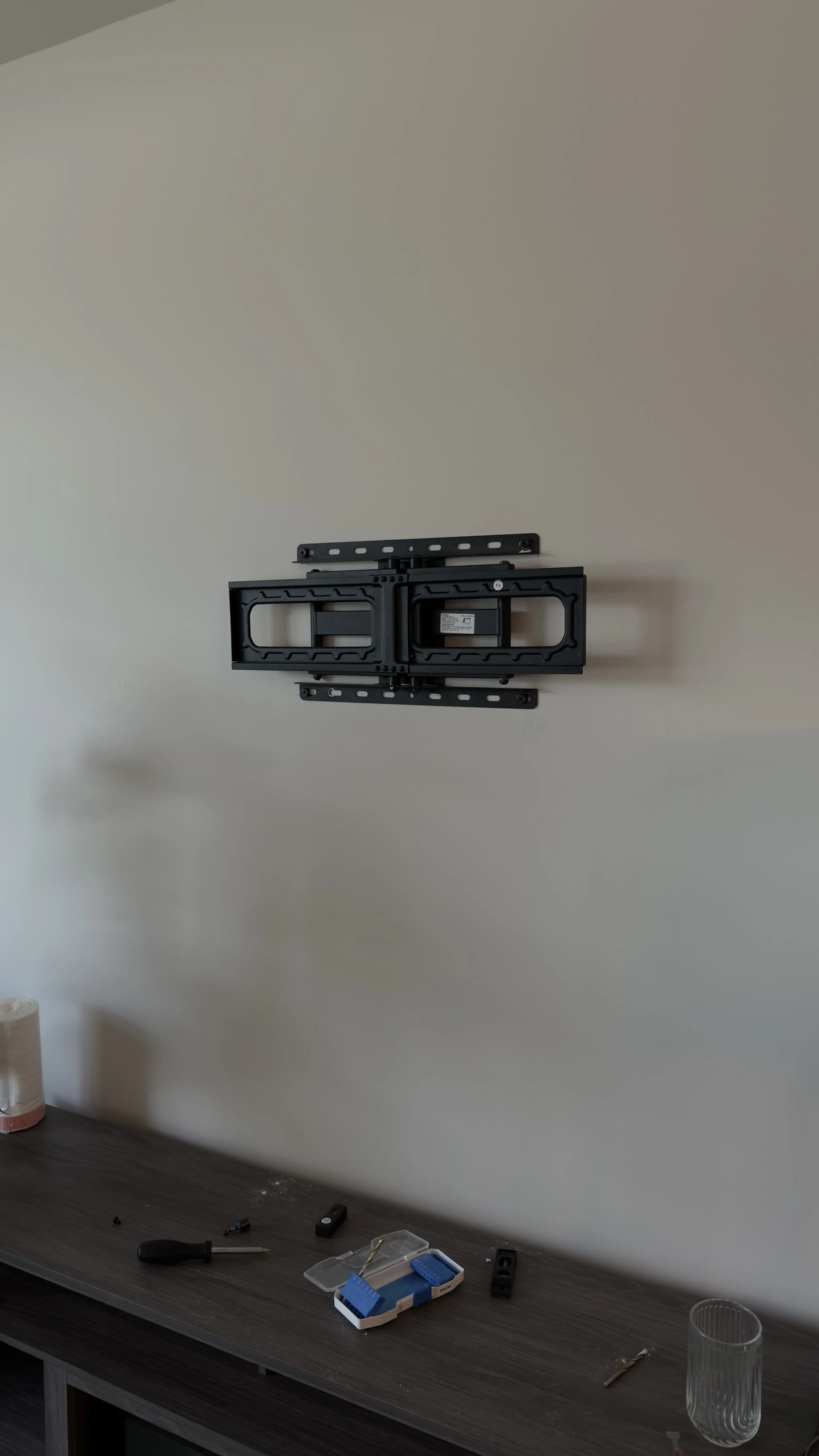 Full-motion TV wall mount securely installed and ready for television mounting.