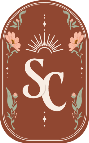A vertical badge with a brown background, featuring white initials 'SC' in the center, floral decorations with pink flowers and green leaves on the sides, and a sunburst design above.