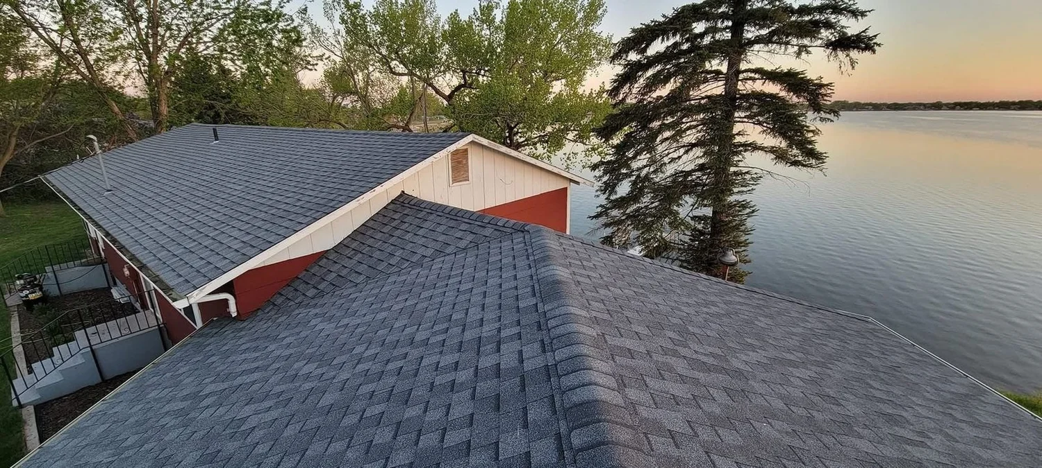 Lakefront home roof replacement at dusk near Harrisburg, South Dakota