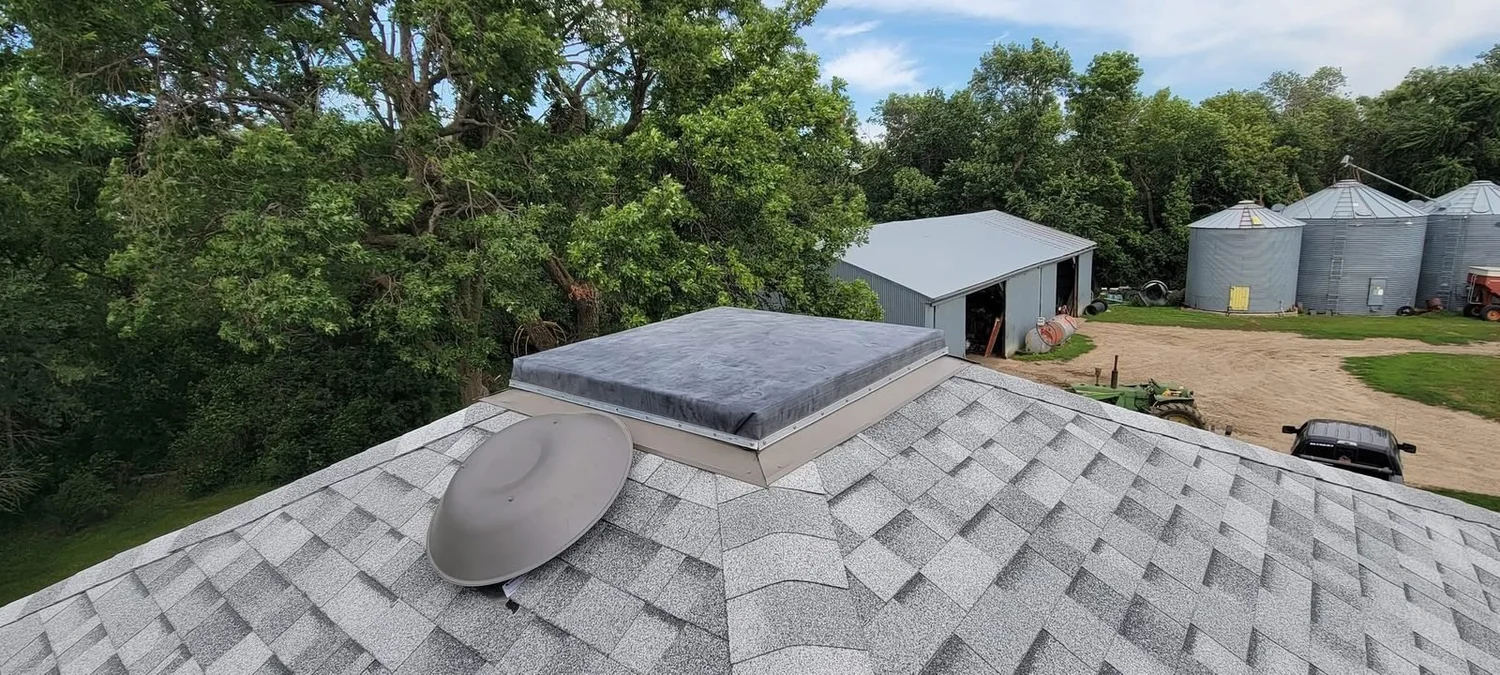 Acreage roof replacement with a rubber flat roof section in southeastern South Dakota