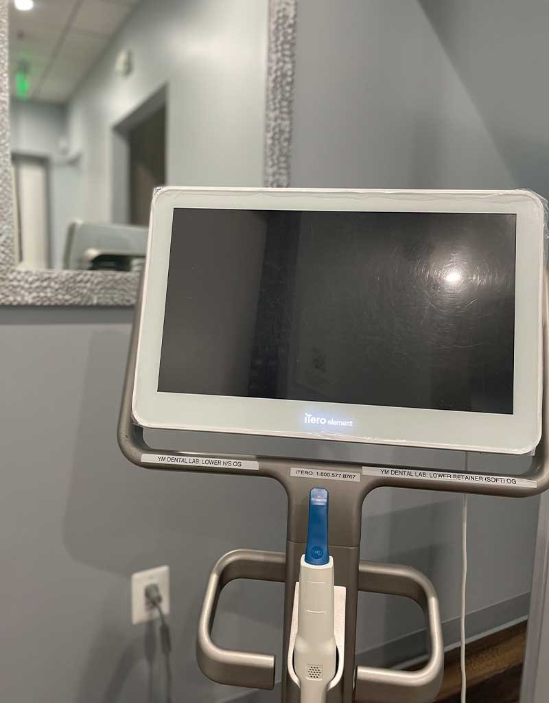 A medical monitor on a stand at a dental office.