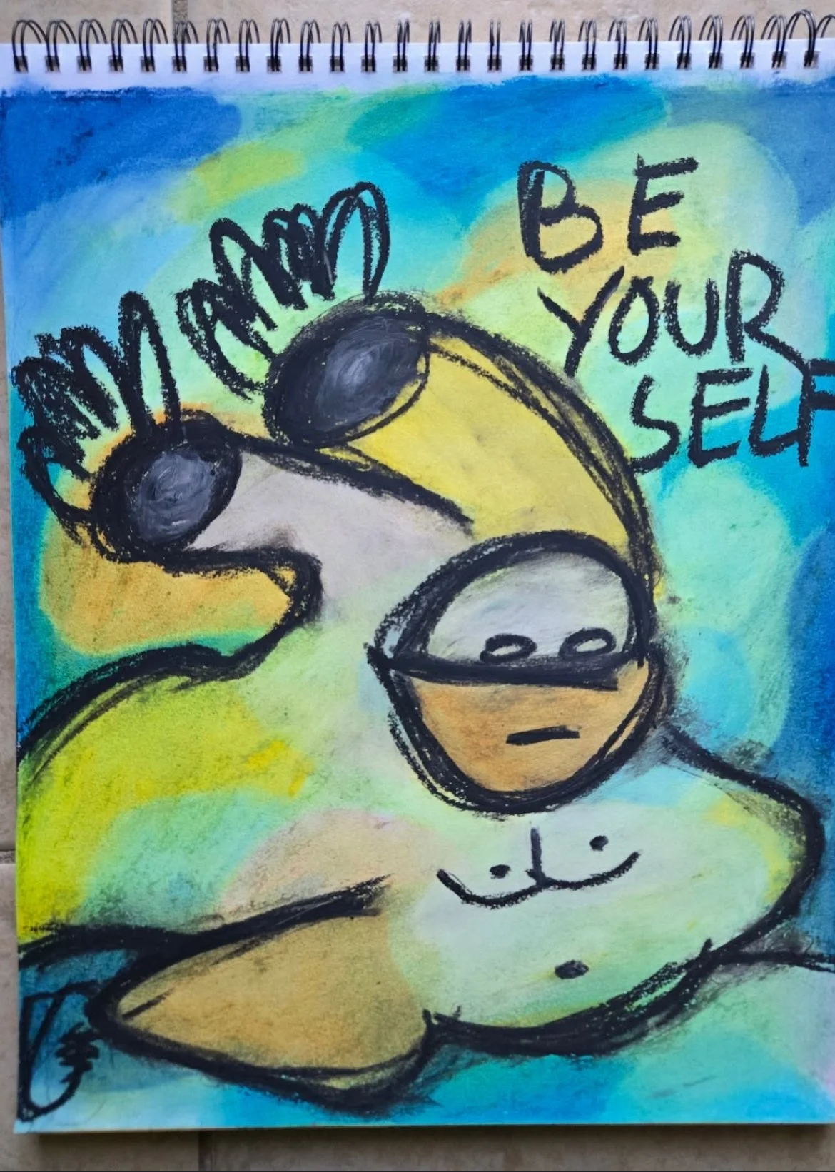 A colorful drawing features a hand with sunglasses, a stressed face with a frown inside a coffee cup, and the phrase "Be Yourself" written in black. The background has blue, yellow, and green watercolor-like patches.