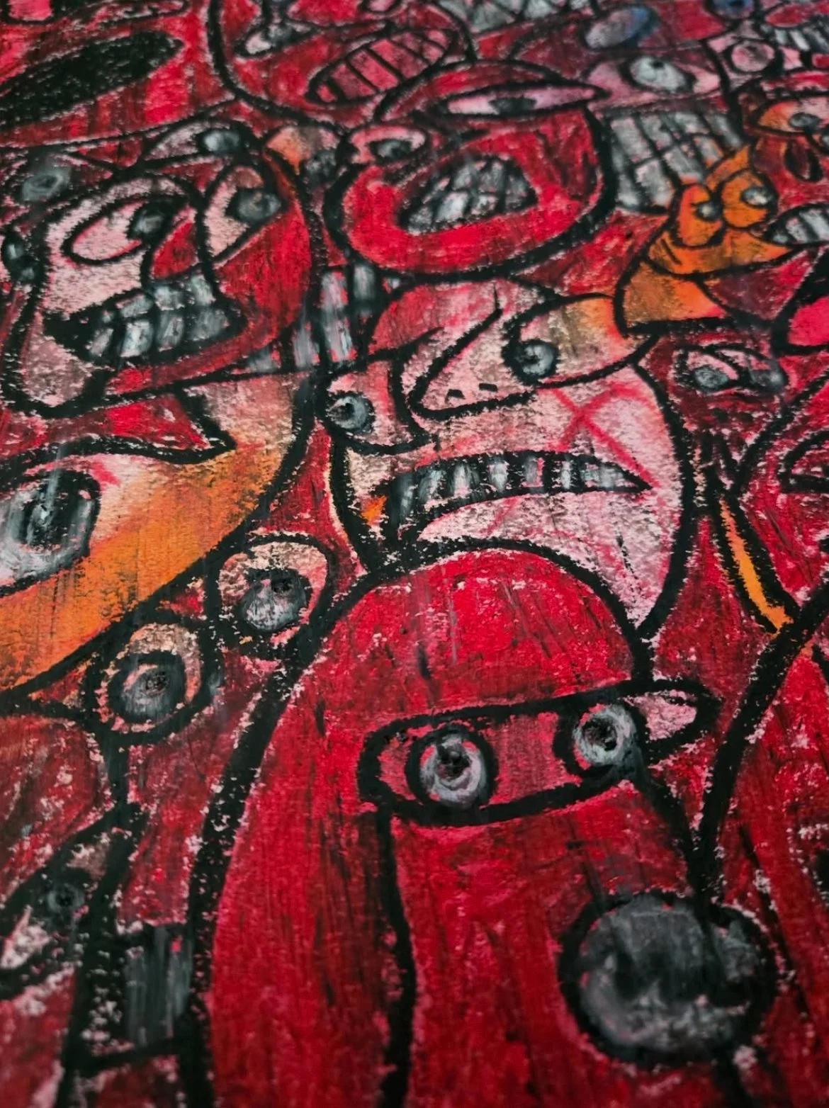 Abstract artwork with red, black, pink, and orange colors featuring angry faces and robotic elements.