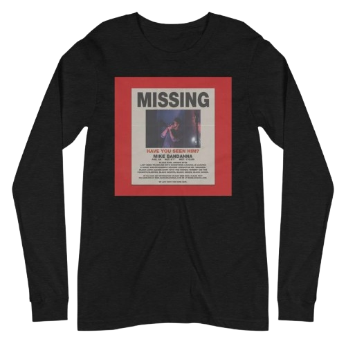 Black long-sleeve shirt featuring a missing person poster with the word 'MISSING' at the top, a photo of a person in a dark setting, and text below about the person and contact information.