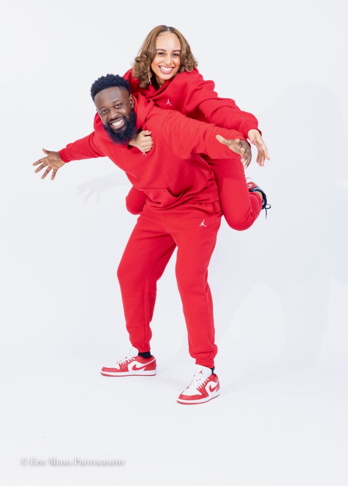 Pastor Matt and Lady Rhesa Quainoo smiling in red sweatsuits
