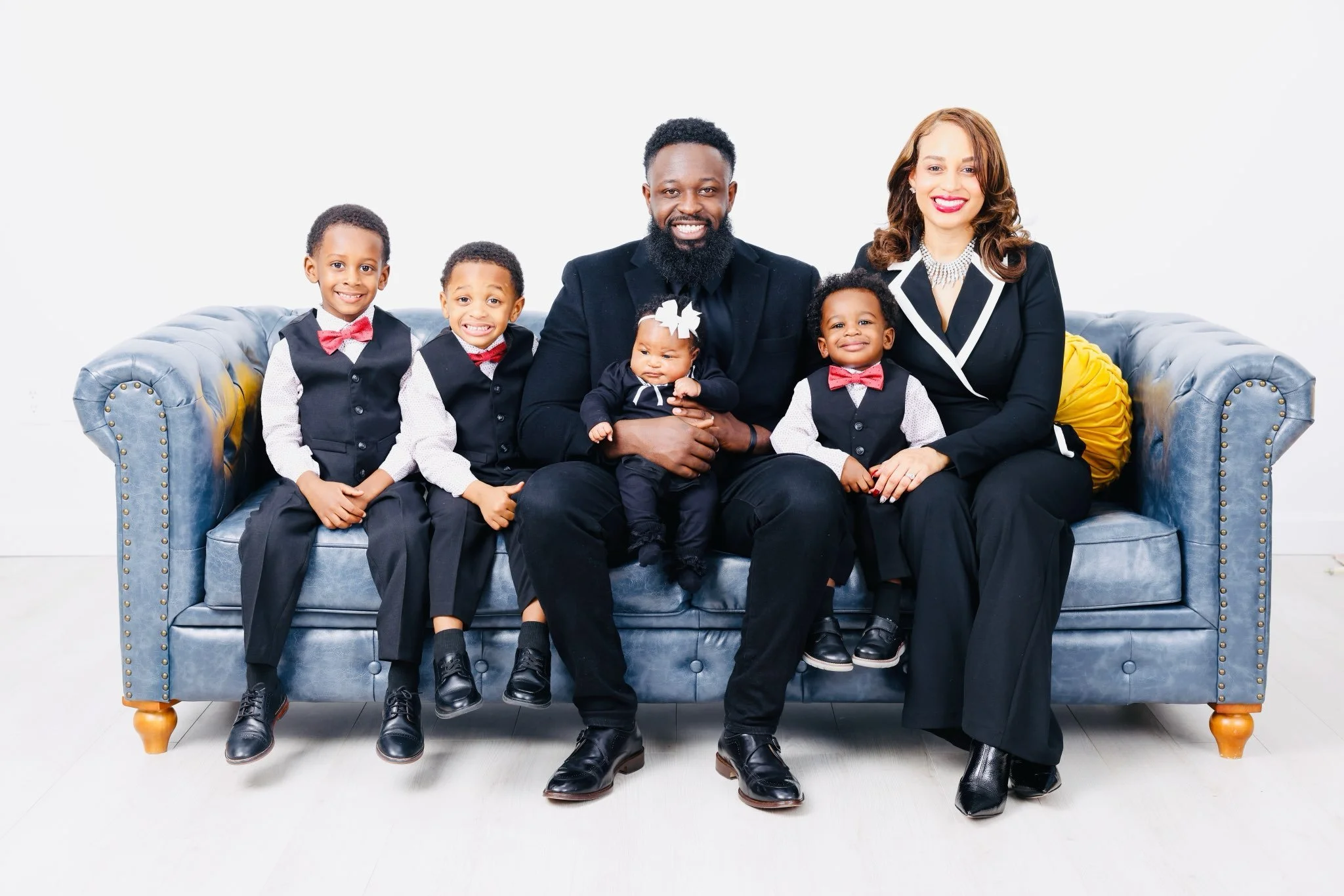 Pastor Matt and Lady Rhesa Quainoo on a couch with their four children