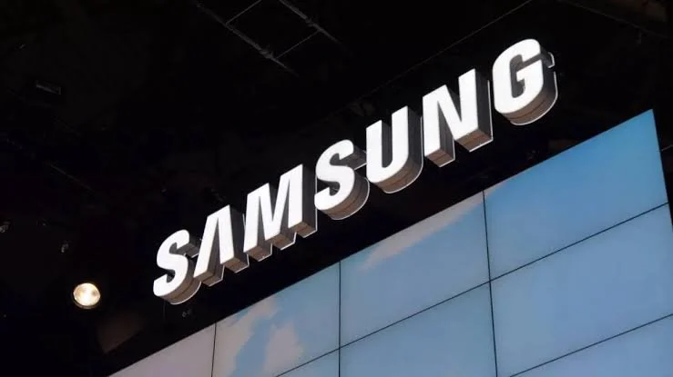 Samsung logo illuminated above a display wall with a digital screen.