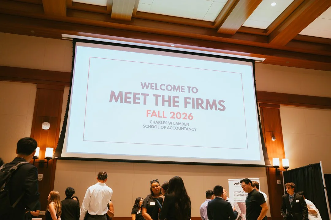 Conference room with people attending a meet and greet event for firms, large screen displays a welcome message for 'Meet the Firms Fall 2026' at the Charles W. Lamden School of Accountancy.