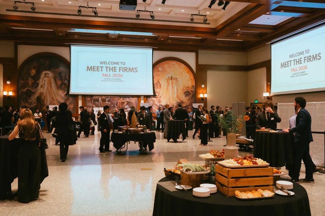 Conference room with attendees, large screens displaying 'Welcome to Meet the Firms Fall 2026 Charles W. Landon School of Accountancy,' and buffet tables with food.