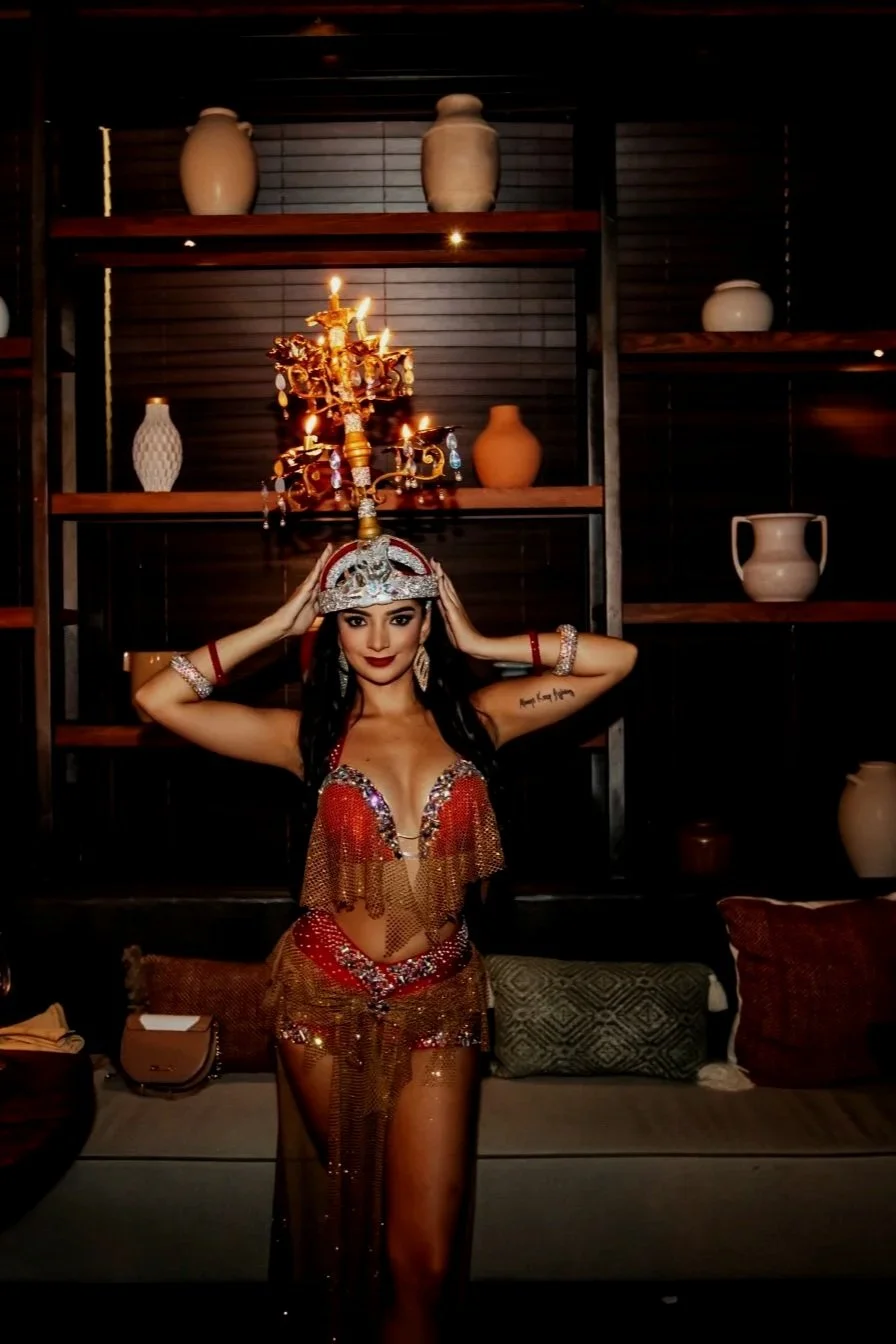 Isabella Damiani, professional bellydancer in Miami, performing in an embellished Oriental dance costume with a candle headpiece.