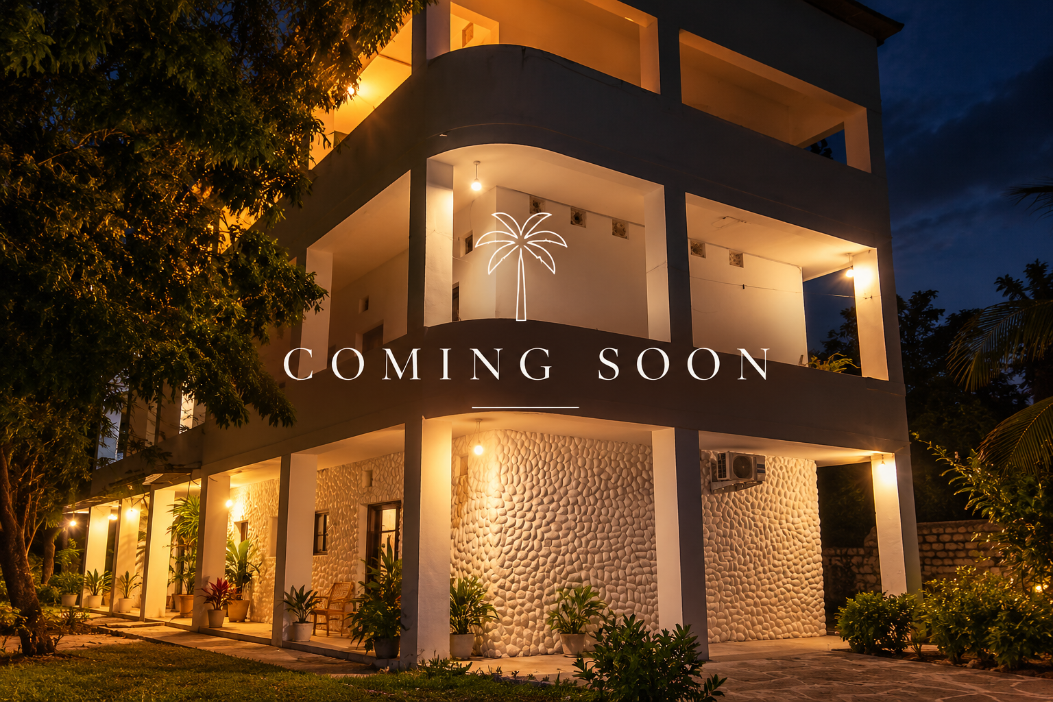 Multi-story modern house at night with illuminated exterior lights and potted plants, featuring white textured wall and open balconies. Overlay text says 'Coming Soon' with a neon palm tree icon.