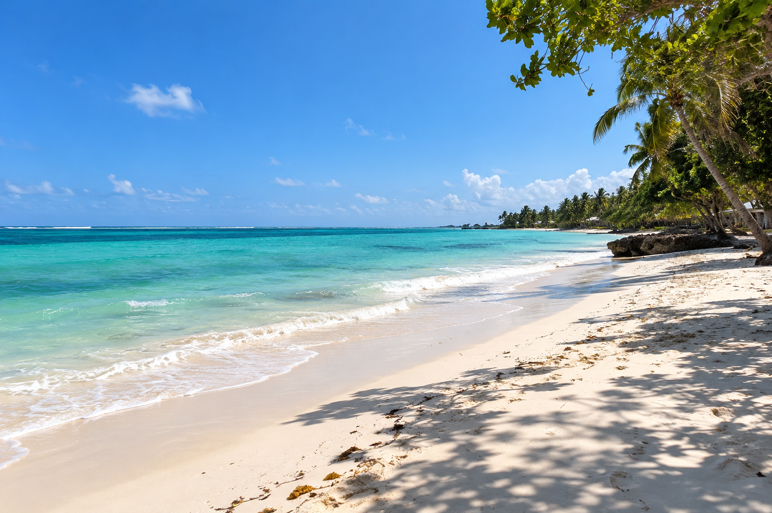White sand and turquoise Indian Ocean water at Galu Beach near The Suites in Diani Beach.