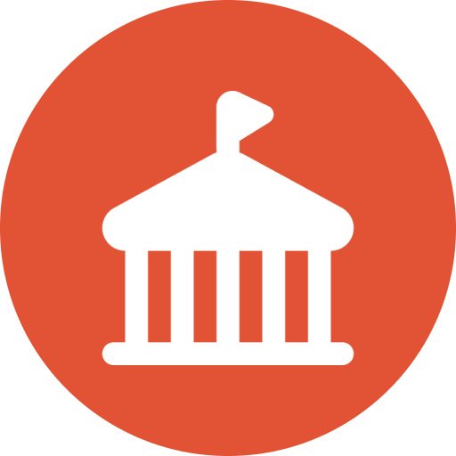 Icon of a classical building with a flag on top, representing a government or institutional building, on a red circular background.