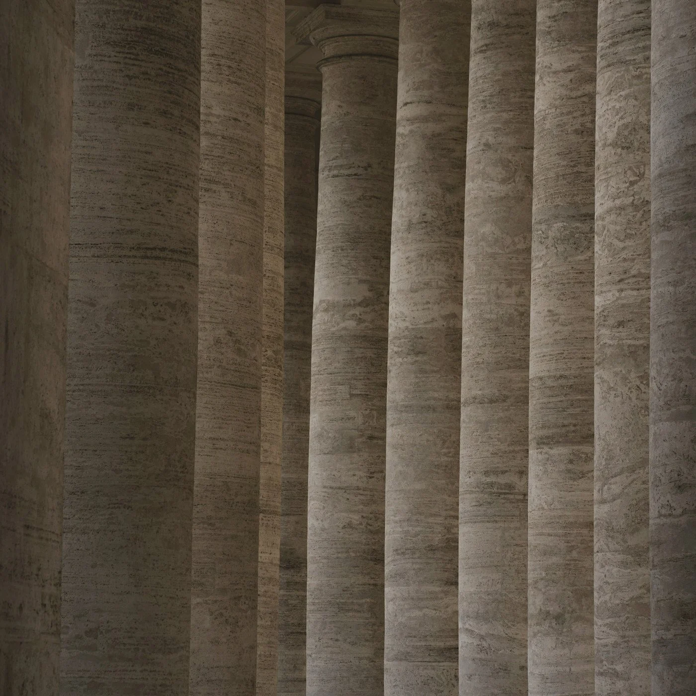 Interior view of massive weathered stone columns in a classical colonnade