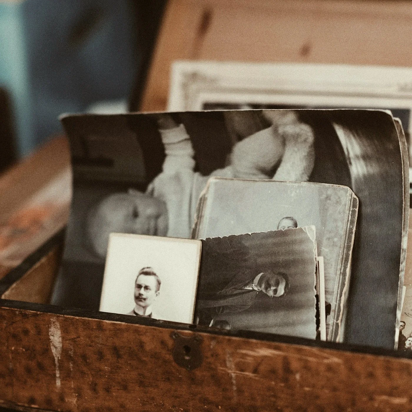 Vintage photographs and papers stored in an open wooden drawer