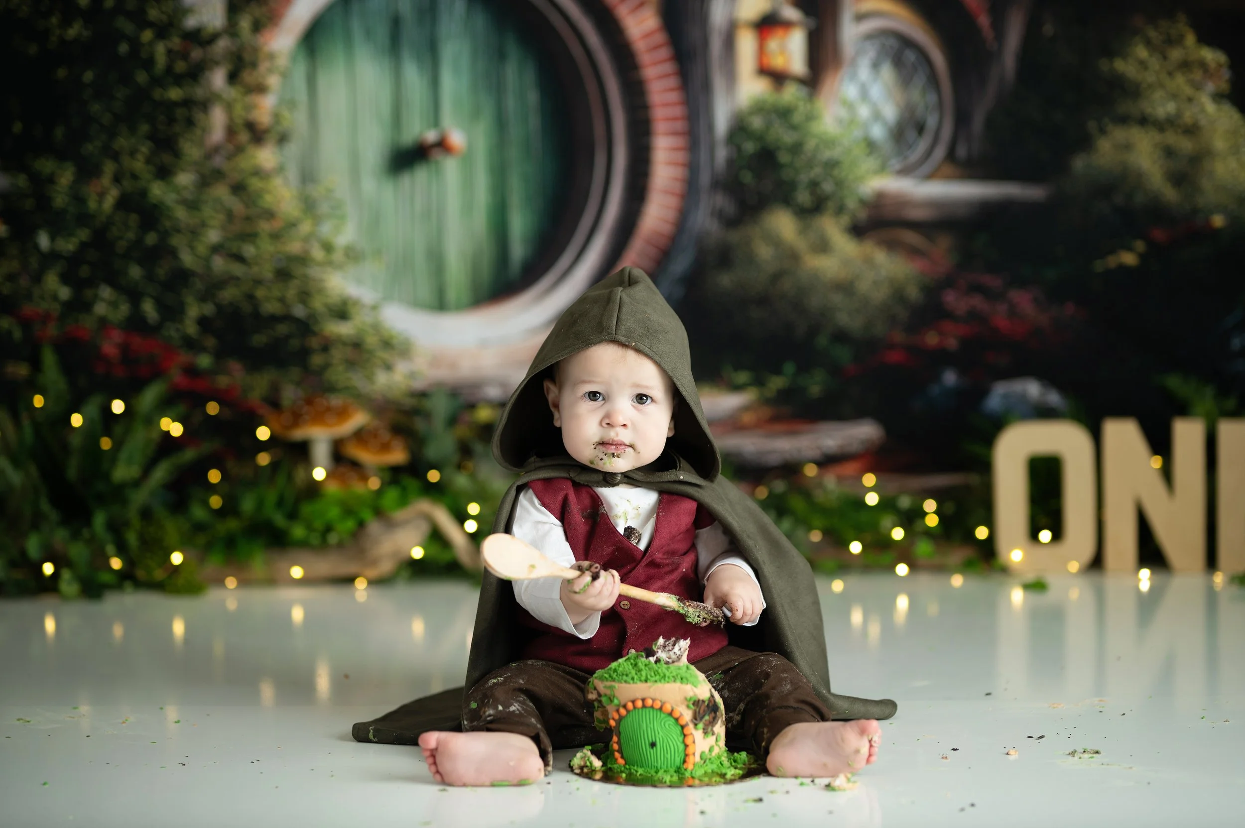 Baby dressed in a fantasy costume during a themed Cake Smash photography session in Millersville, Maryland.