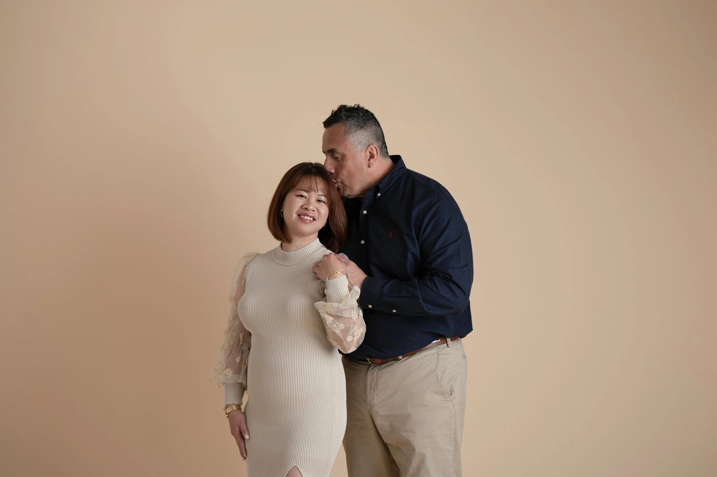 Couple sharing a joyful moment during a simple studio portrait session.