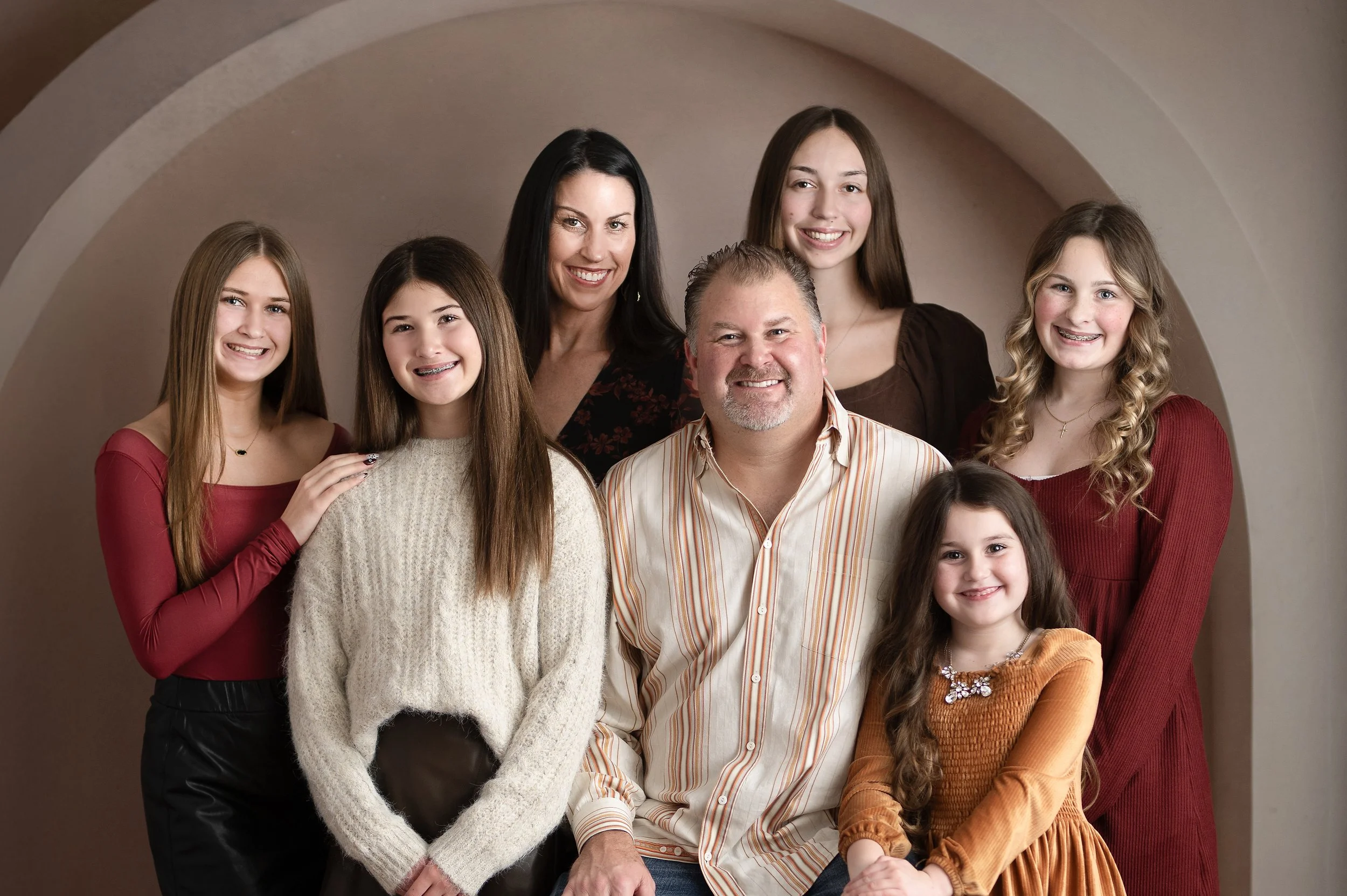 Family of seven posing together during a studio family portrait session in Millersville, Maryland.