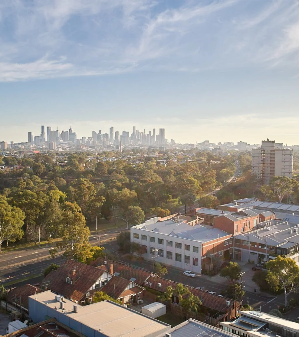 Melbourne skyline with NorthSpace studio and Heidelberg Rd in the foreground with Yarra Bend Park on a clear day.