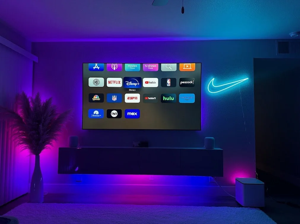 Illustration of a home theater concept with a wall-mounted display and media console.