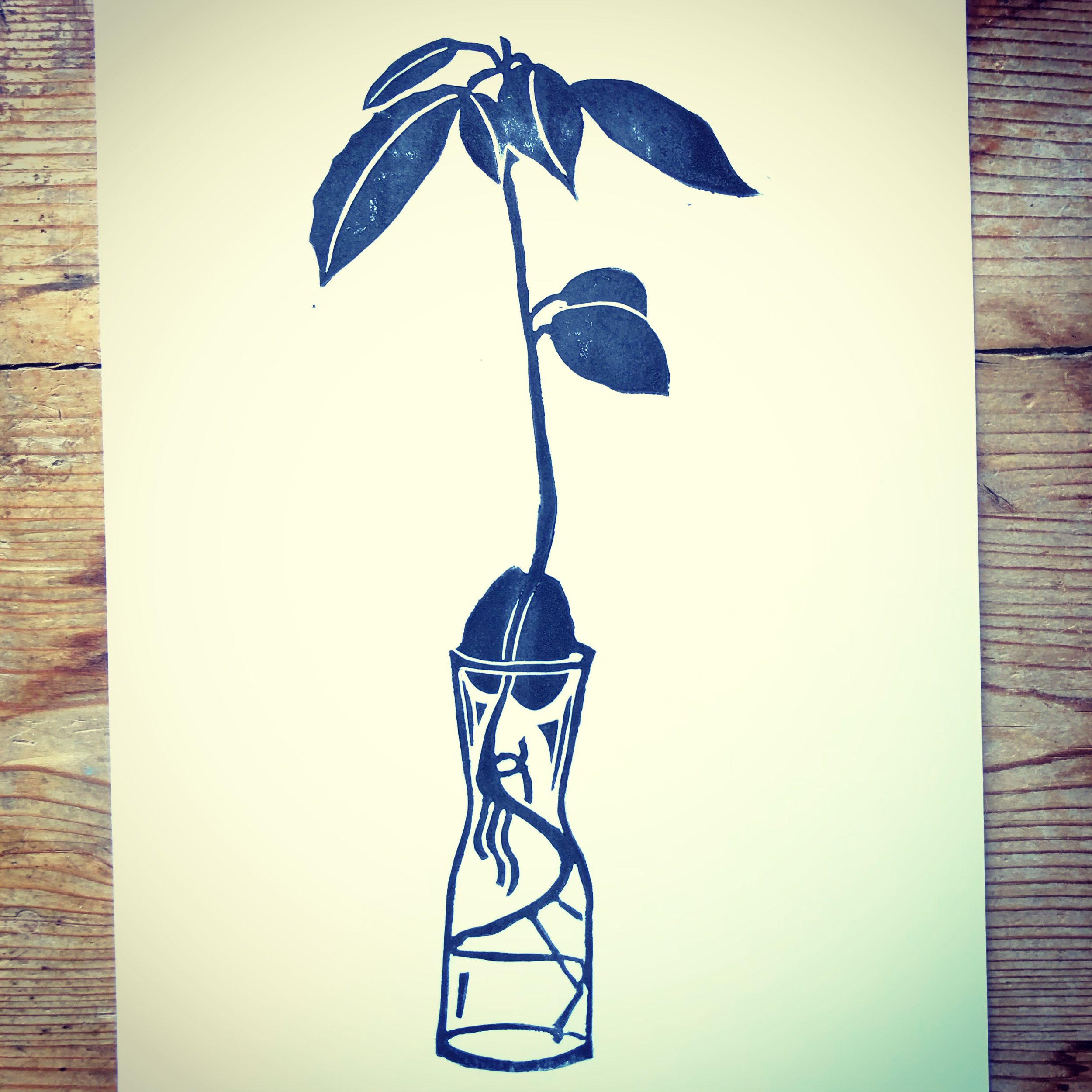 A black stencil-style drawing of a glass with a cocktail umbrella and a straw, standing on a flat surface, on a white background.