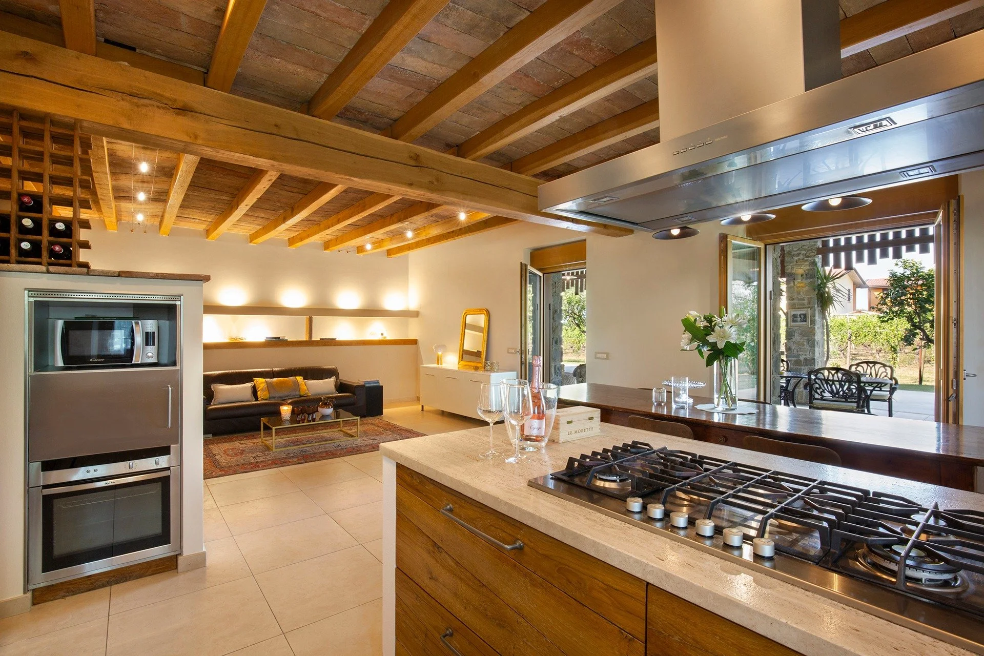 Fitted kitchen with exposed wooden ceiling
