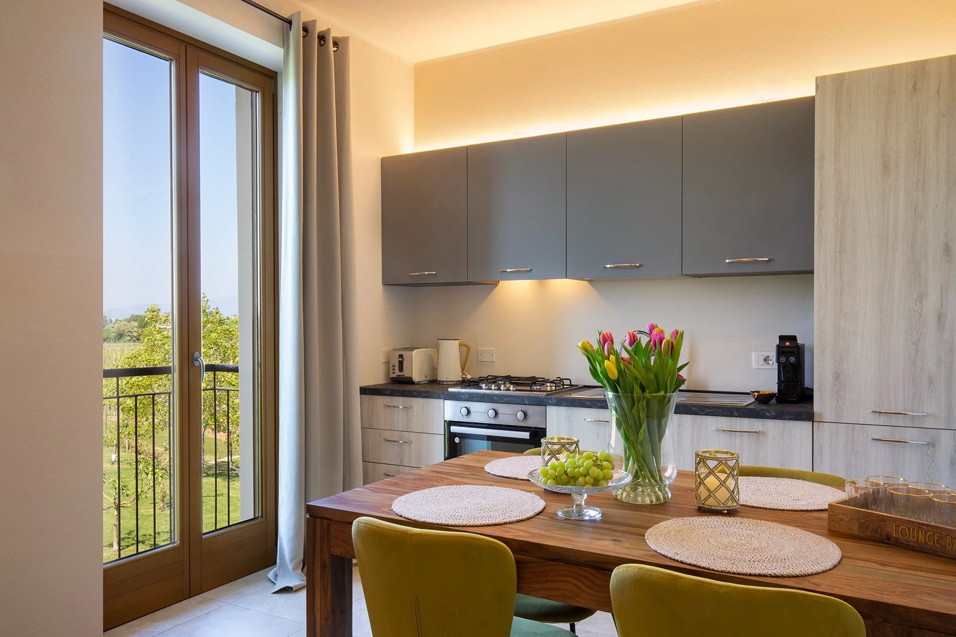 Dining area of an apartment with kitchen and French window