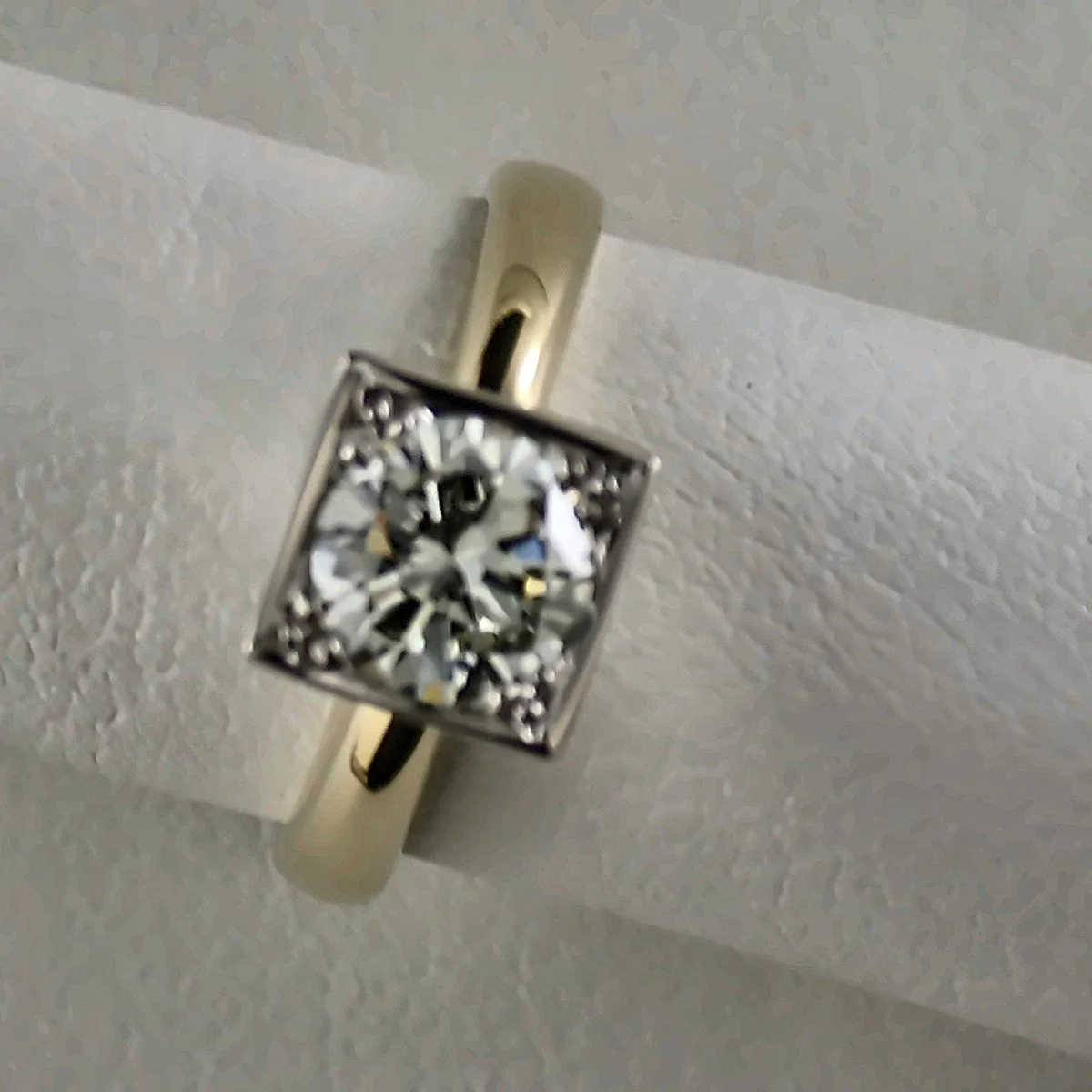 Close-up of a two-tone ring with a princess cut diamond.