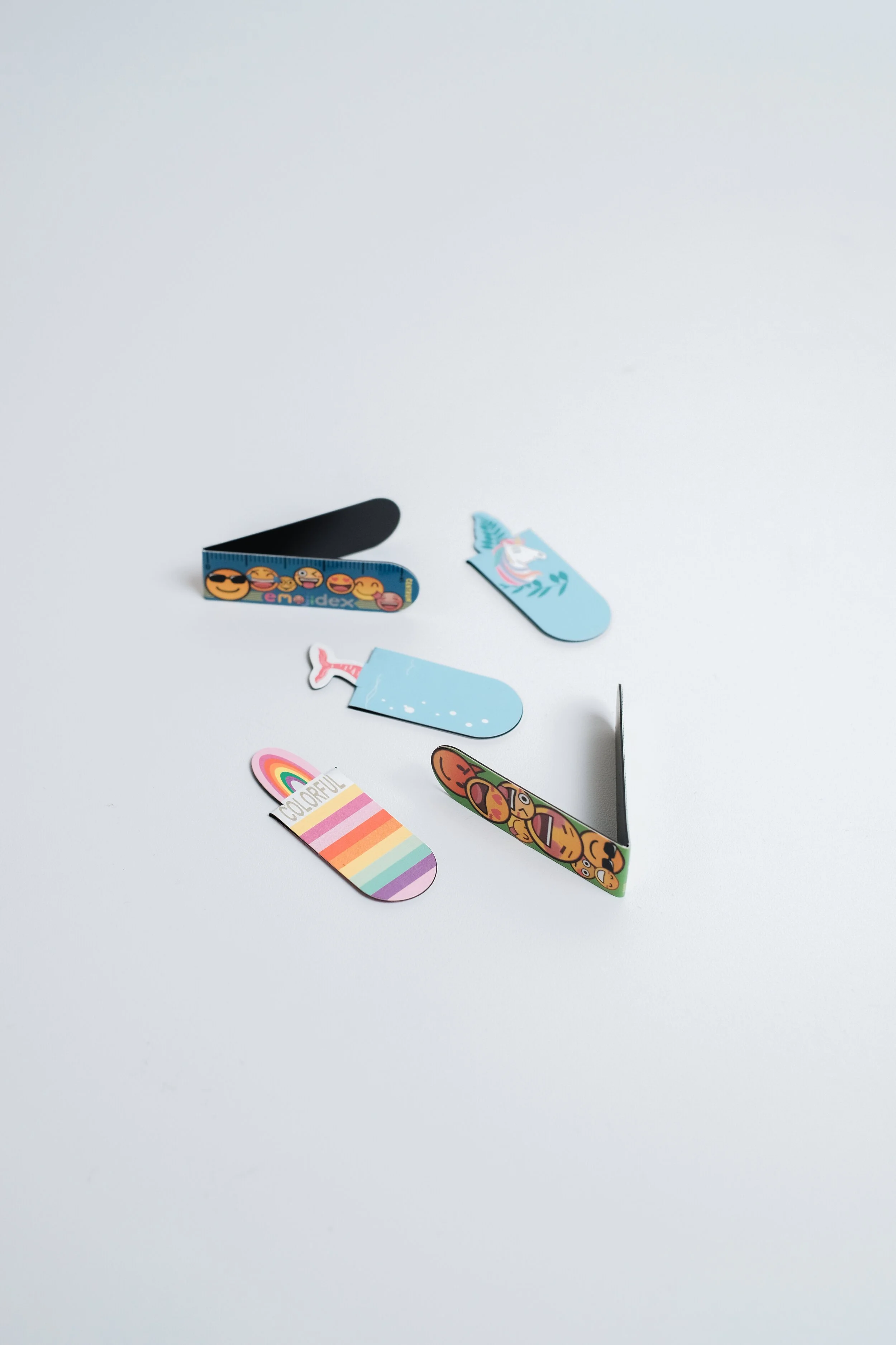 Custom printed magnetic bookmark folded over a page