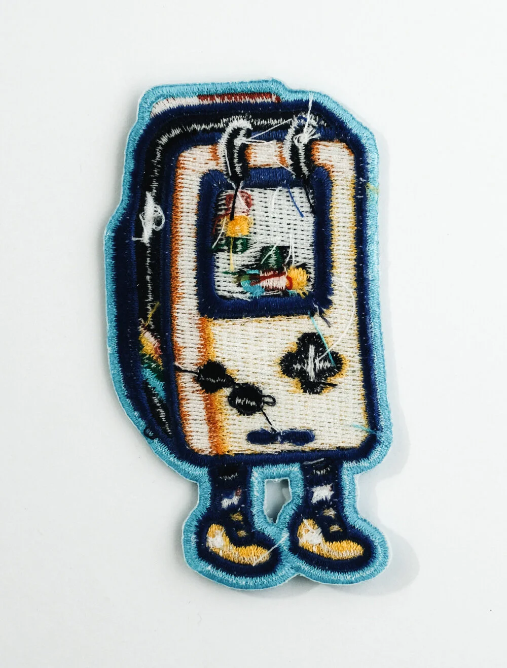 Rear of a patch showing iron on backing, a heat activated adhesive layer for fixing with a household iron