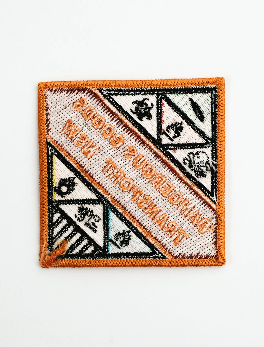 Rear of a patch with plain backing, leaving the stitching and twill exposed so it stays flexible for sewing