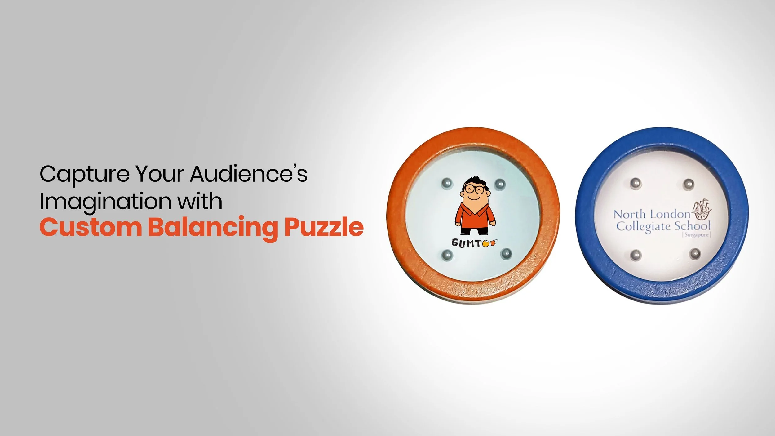 Two round custom balancing puzzle games with metal balls and printed logos in orange and blue frames, brain-teaser giveaways for schools and trade shows, retail merchandise Malaysia